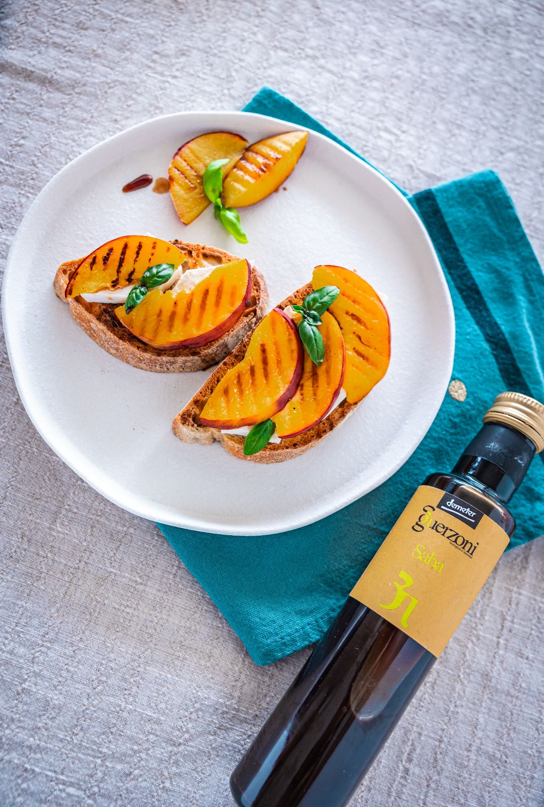 Summer bruschetta with primo sale, grilled peaches and balsamic saba: a symphony of summer flavours!